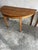 Elegant pair of antique demi-lune console tables crafted in solid wood with beautifully tapered legs and a warm patinated...