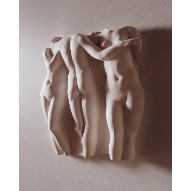 Vintage wall sculpture depicting the Three Graces in high relief composition. Features three intertwined female figures...