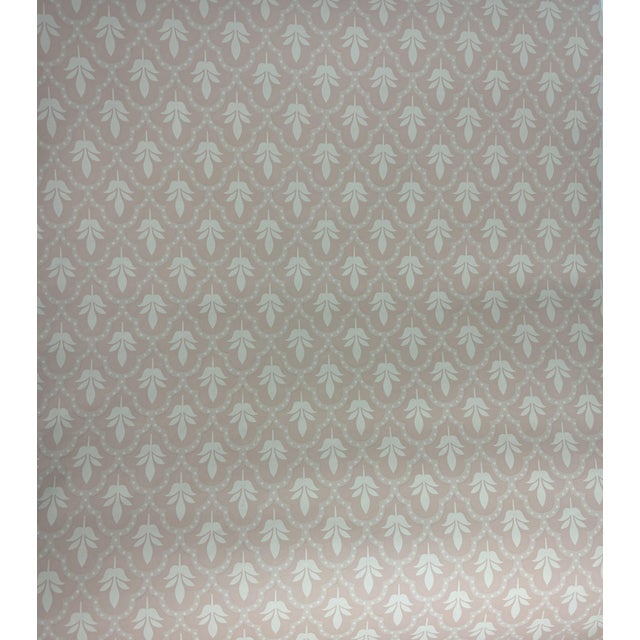 This is a beautiful, peachy-pink wallpaper with a pattern in a sandy cream. It is a Nina Campbell wallpaper distributed by...