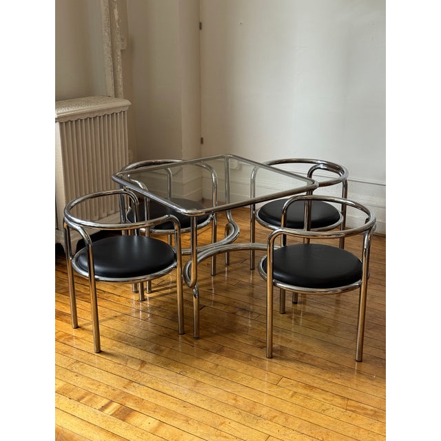 Exuberant "Locus Solus" dining chairs and table set, designed by Gae Aulenti for Poltronova circa 1964. With bent tubular...