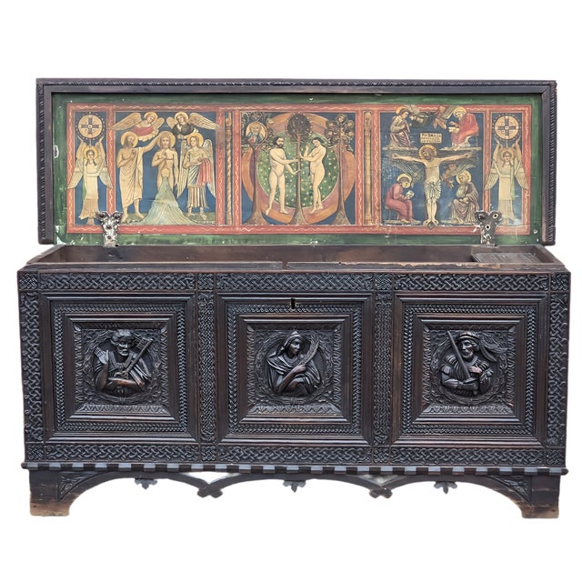 A hand-carved walnut chest in neo-medieval style, dating back to the 19th century, likely made in northern Italy, in the...