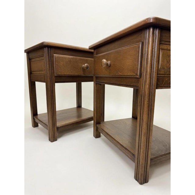 Elevate your space with this pair of late 20th century solid oak nightstands. These country-style side tables are the...