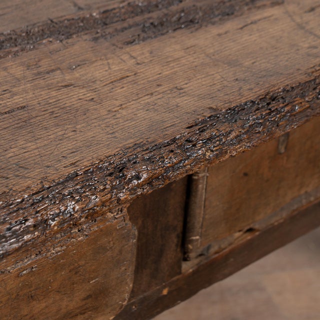 This rustic dark oak coffee table features two drawers with iron pulls. The extensive wear and distress are what give this...