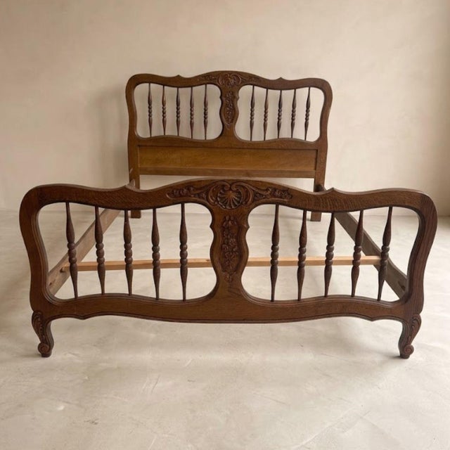 Elegant vintage bed frame featuring richly carved wooden details and a classic decorative structure. The design includes a...