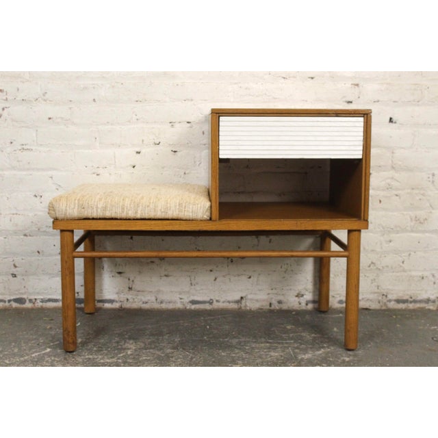 This oak telephone bench was designed by Raymond Lowey for Mengel Furniture Co. With its timeless mid-century design and...