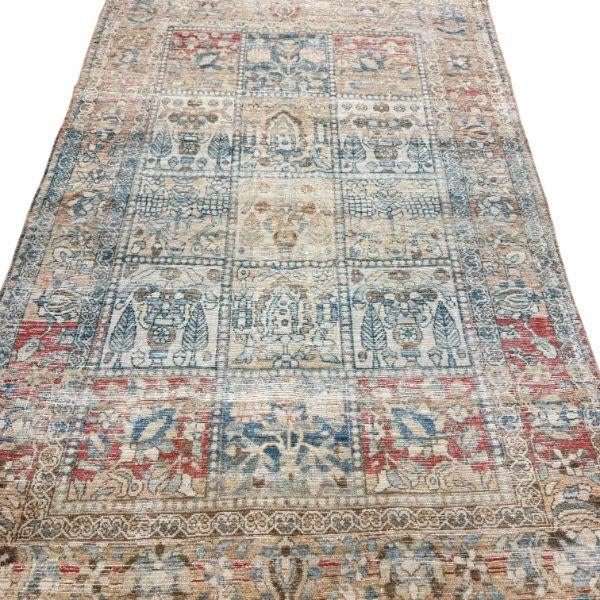 This distinctive antique rug features a beautiful and unusual tile-like design filled with stylized botanical motifs....