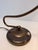 A beautifully designed vintage brass desk lamp featuring an elegant flowing arm and compact circular base. Its timeless...