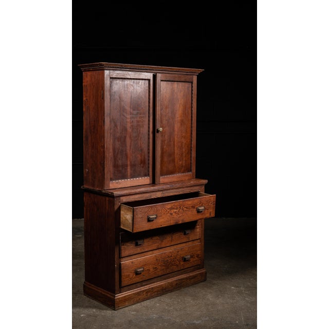 This antique cigar cabinet was made by The Central Cigar Company in the early 20th century. It features three pull drawers...