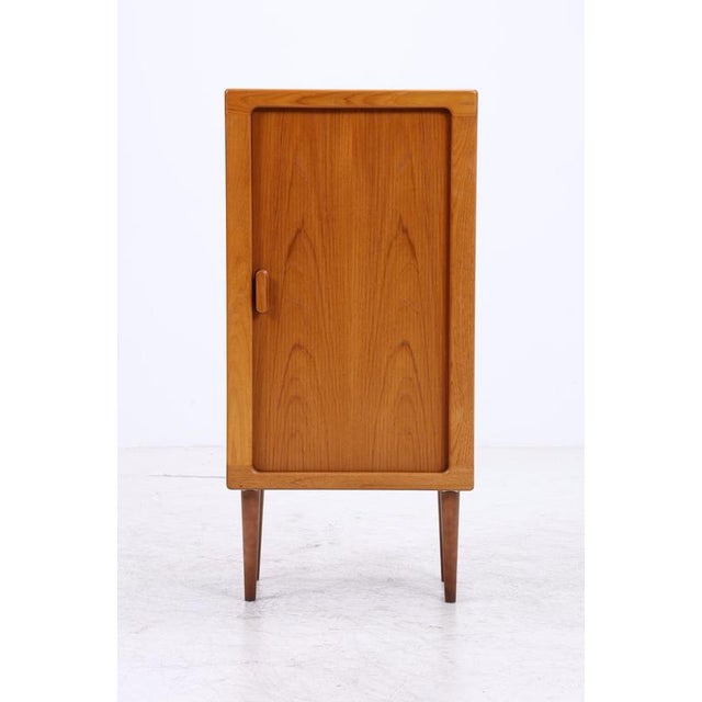 Vintage chest of drawers by CFC Silkeborg with a large door and clean, straight lines. The softly rounded edges, recessed...
