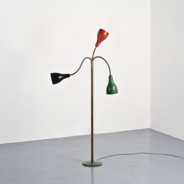 Three-arm adjustable floor lamp produced by O'Luce in Italy around 1950. Made of brass, it rests on a circular, green...