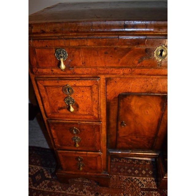 For lovers of a more formal fare, a banded, veneered walnut kneehole dressing table or desk from the early 1700s. The 30...