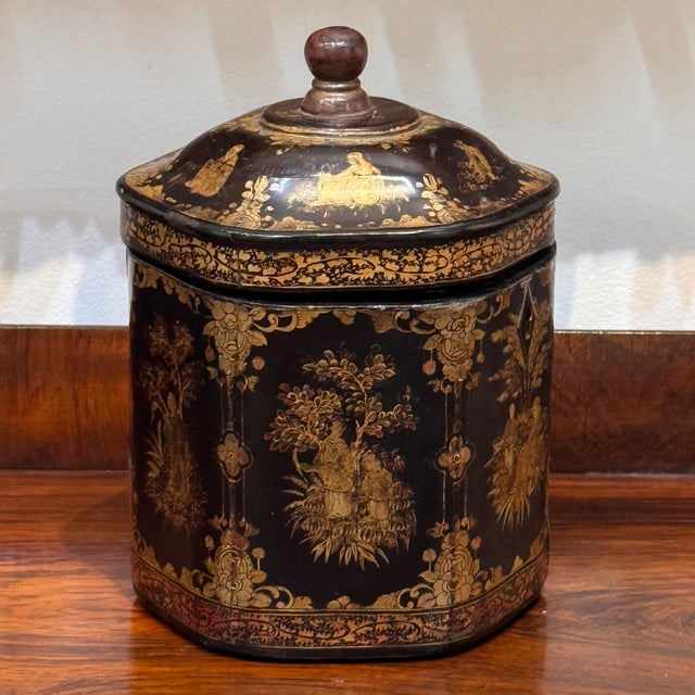 A Chinese export tea caddy dating from the first half of the 19th century of cylindrical octagonal form in black lacquer...