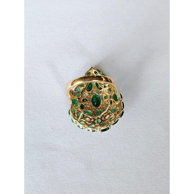 A very gorgeous and beautiful, modern style Emerald Cocktail Ring set in 18K Yellow Gold & natural Diamonds. The weight of...