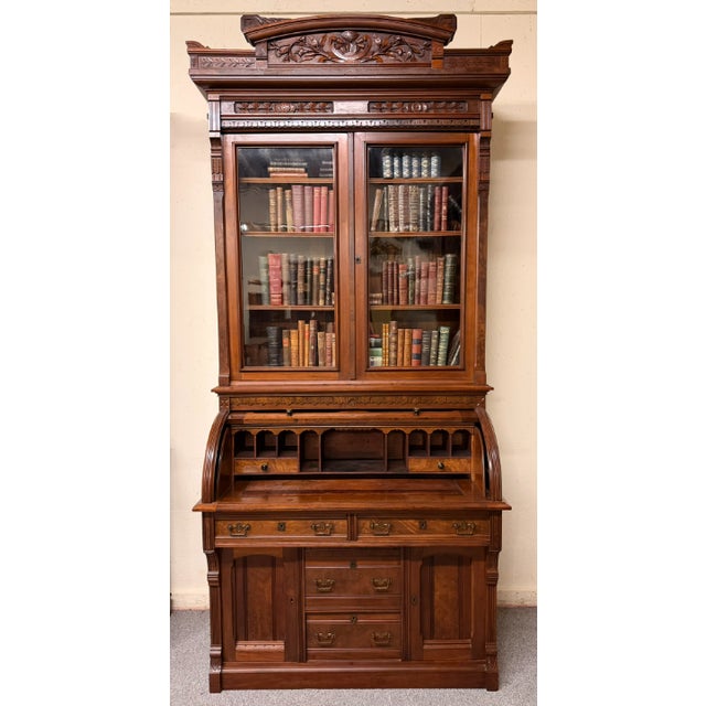 American Eastlake Victorian cylinder roll top desk featuring burl walnut with walnut panels on the exterior face and the...