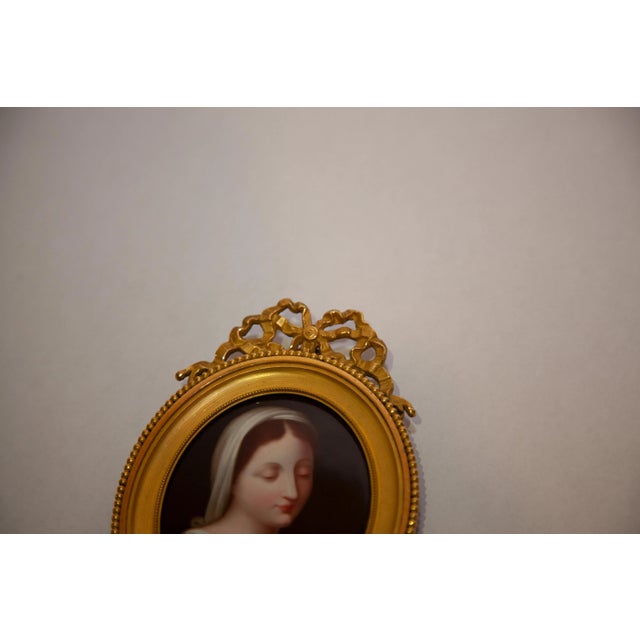 Louis XV gilded metal with a beautiful tied ribbon at the top. Porcelain plaque in frame of the virgin Mary. Purchased...