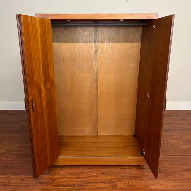 G-Plan Quadrille large teak armoire wardrobe with a set of bi-fold doors and a single swinging door to open the whole...