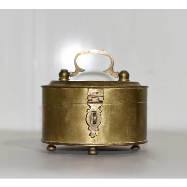 A small decorative piece with timeless charm, this mid century brass trinket box features Chinoiserie-inspired detailing...