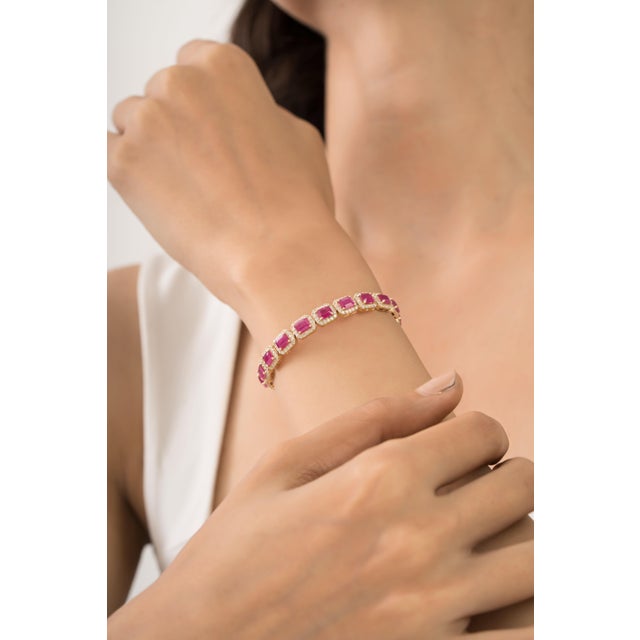 This statement tennis bracelet featuring a 10.41 carat of rectangular-cut rubies set in 14K yellow gold. Each measuring...