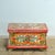 This folk art box from the 1930s is a particularly decorative object with an authentic, hand-painted appearance. The...