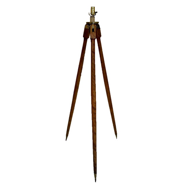 A striking early 20th-century surveyor’s tripod, thoughtfully converted into a sculptural floor lamp. This piece retains...