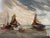 Antique oil painting of a seascape. The scene features a landscape style painting with sailboats under a cloudy sky....