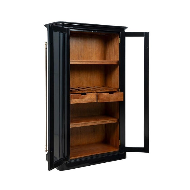 The Veneto Solid Wooden Black Bookcase delivers striking visual impact through its glossy black finish and gold hardware...