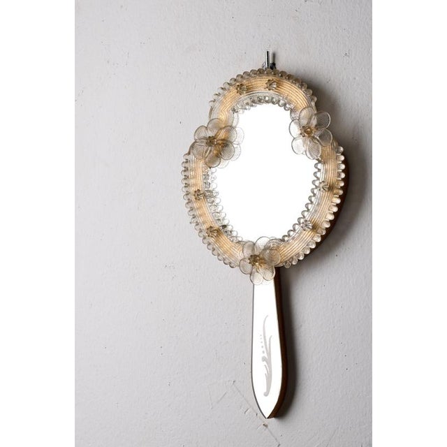 This vintage Italian Murano glass Venetian hand wall mirror is a charming example of traditional Venetian craftsmanship....