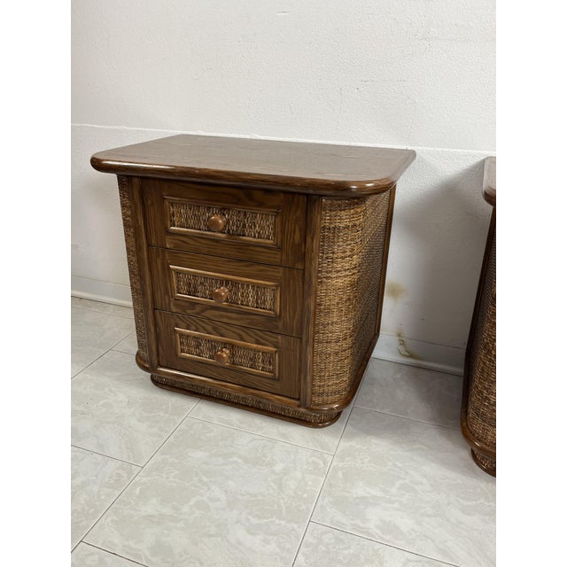 Set of 2 walnut and rattan bedside tables, Made in Italy from the 70s Intact and in excellent condition. Three drawers on...