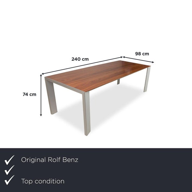 Here you'll find a dining table from the German manufacturer Rolf Benz, whose warm wood top and light metal frame add a...