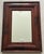 A handsome American Empire wall mirror featuring a rich mahogany frame with broad cushion molding and finely mitered...