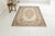 This is a vintage Turkish Oushak rug from the Mid 20th Century. The piece was hand-knotted.