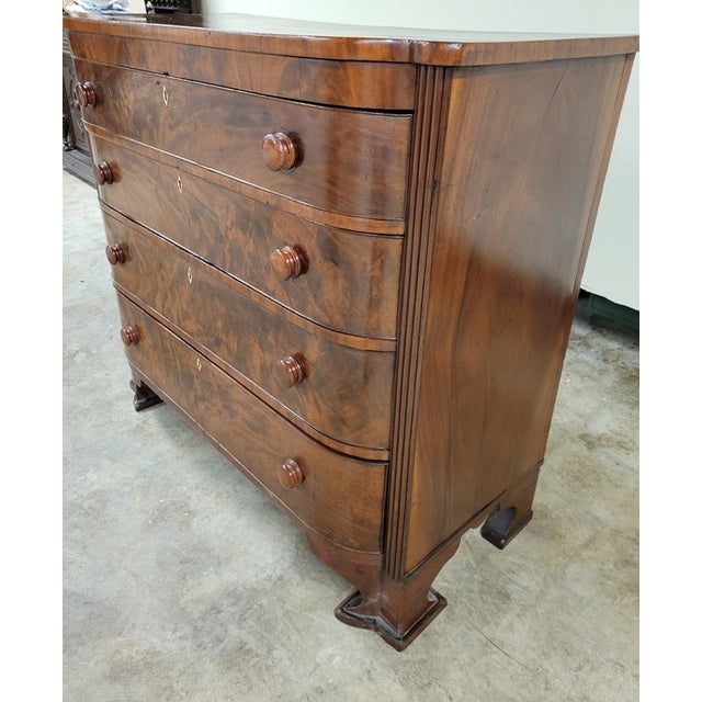 Early 19th-century American Empire bow-front chest of drawers, circa 1830, with richly figured mahogany veneer, four...