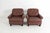 A pair of relaxing tufted leather lounge chairs. The chairs are of northern European (German) origin and are upholstered...
