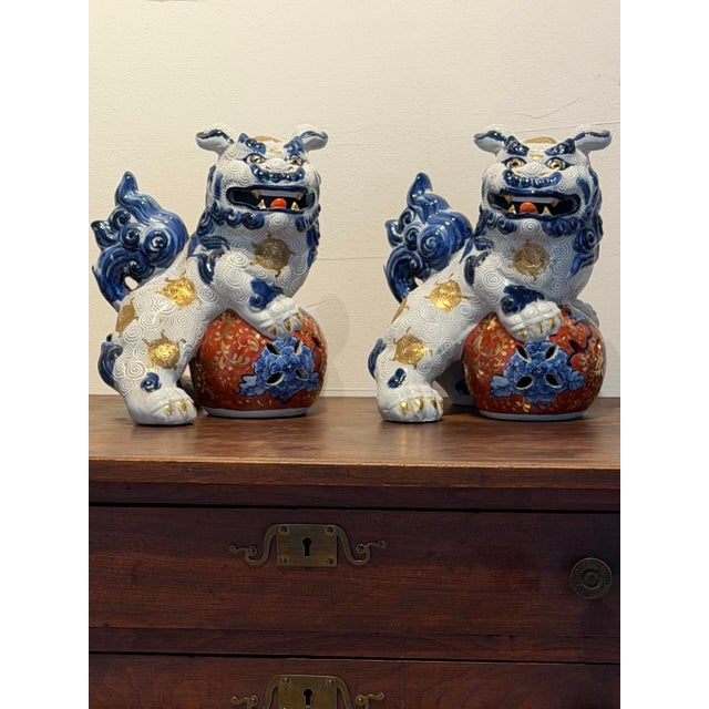 A striking vintage pair of Japanese ceramic Foo Dogs, or guardian lions, with exceptional decorative presence. Rendered in...