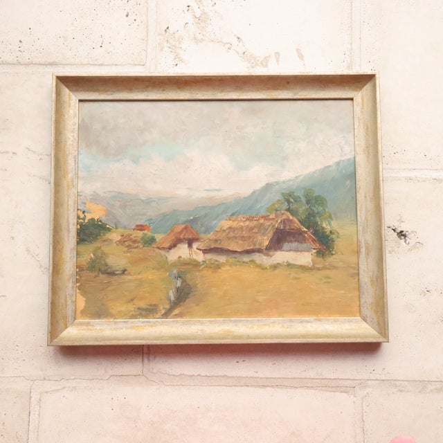 20th Century French Thatched Houses Painting presents a peaceful rural landscape with a small grouping of thatched...