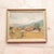 20th Century French Thatched Houses Painting presents a peaceful rural landscape with a small grouping of thatched...