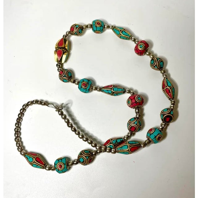 A colorful necklace featuring an assortment of lantern, barrel, bicone and spindle-shaped mosaic inlay beads. Turquoise-...