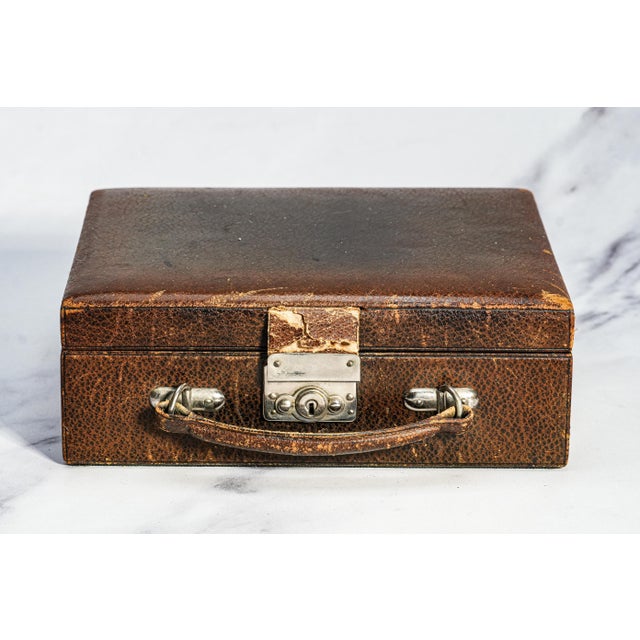 Step back into the elegance of early 20th-century travel with this charming circa 1930s leather travel jewelry case, a...