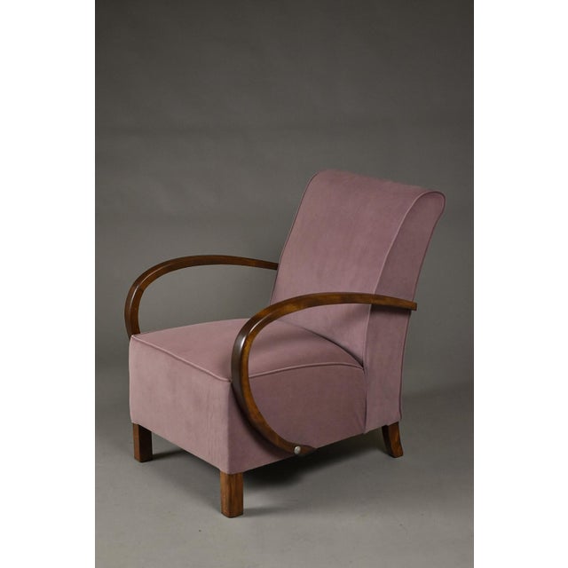 This elegant Art Deco club armchair originates from Poland and dates to the 1930s. The chair features a compact, well-...