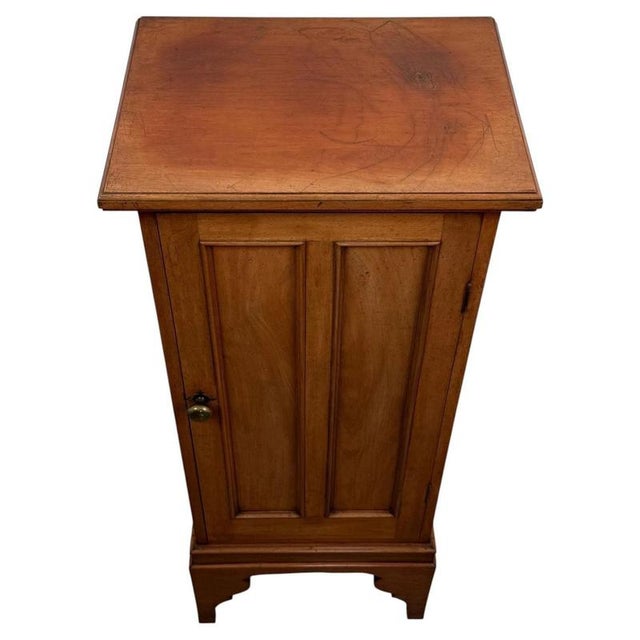 A handsome early 20th-century English cupboard, finely crafted from walnut and distinguished by its tall, slender...
