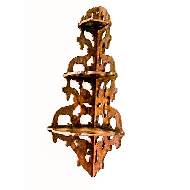 English Regency-style carved stained mahogany fretwork hanging corner shelf/wall bracket with three triangular tiers (ca....