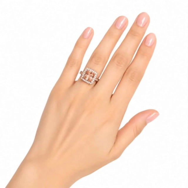 Fabulous 14K white gold cocktail ring featuring a 2 carat natural cushion-cut raspberry garnet center, accented with...