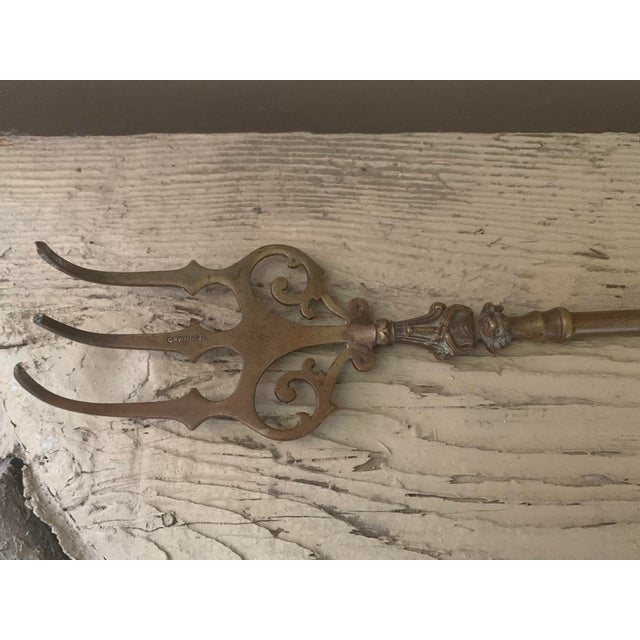 19th C large brass kitchen fork from England. Lovely kitchen accessory