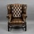 An impressive antique circa 1920 Chesterfield wingback armchair, upholstered in deep-buttoned hand-dyed leather with a...
