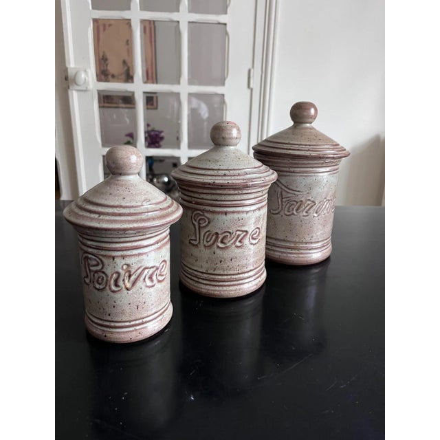 3 pots from the 1970s in ceramic Flour: Height 23cm, Diameter 17cm Pepper: Height 17cm, Diameter 10cm Sugar: Height 19cm,...