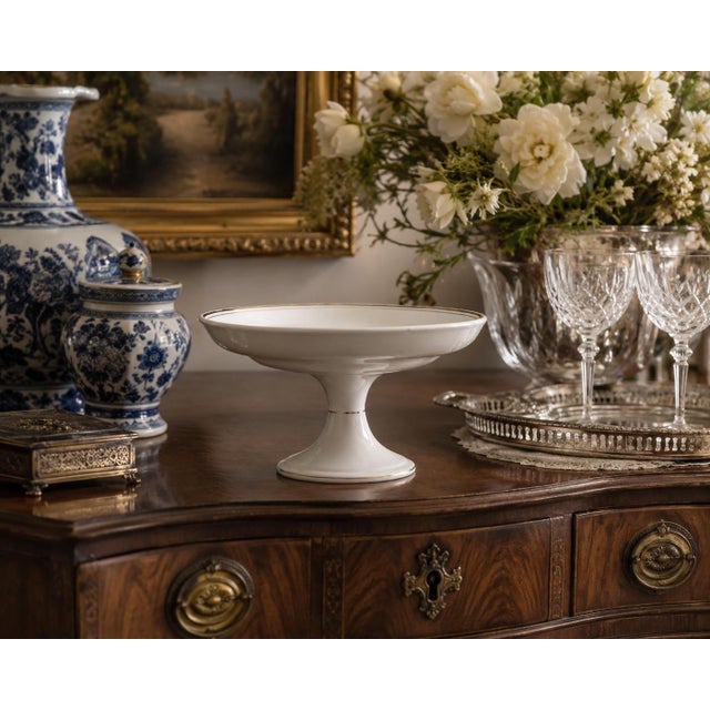 A lovely antique Belgian white porcelain decorative pedestal compote or fruit bowl with gilt details. Made by Boch La...
