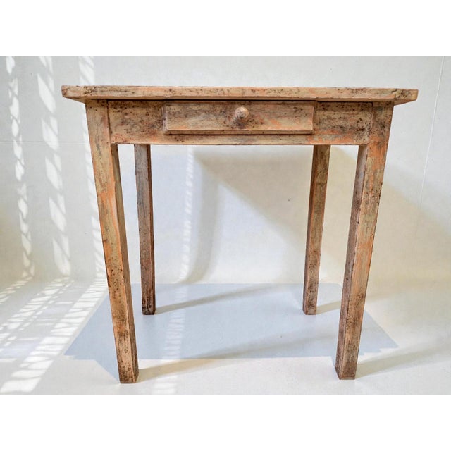 Early 20th-century rustic table, made entirely of solid wood with a patina achieved using natural pigments. It features a...