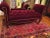 This is a Vintage Queen Ann Style Red Velvet Tufted Ottoman Bench / Entryway Couch Settee with Tall Rolled Arms with Brass...