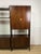Freestanding teak bookcase with brass fittings, consisting of four uprights, three shelves, and five closed elements,...