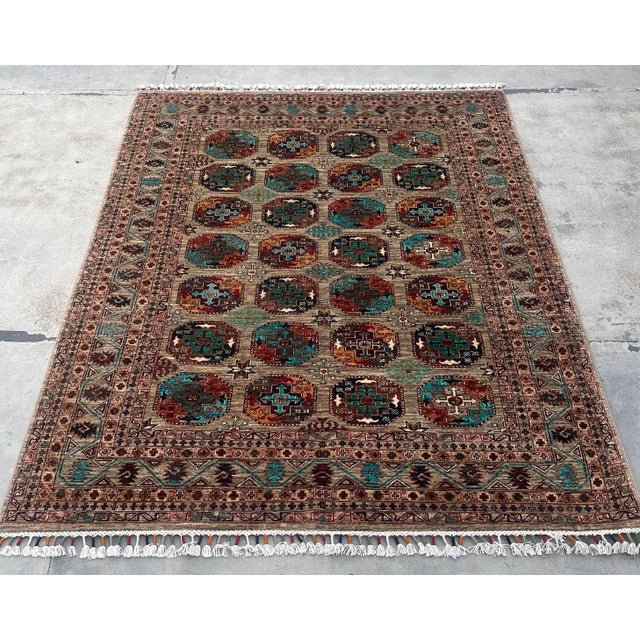 This Vintage Caucasian Kazak Wool Rug showcases the timeless artistry of tribal weaving, featuring a field of repeating...